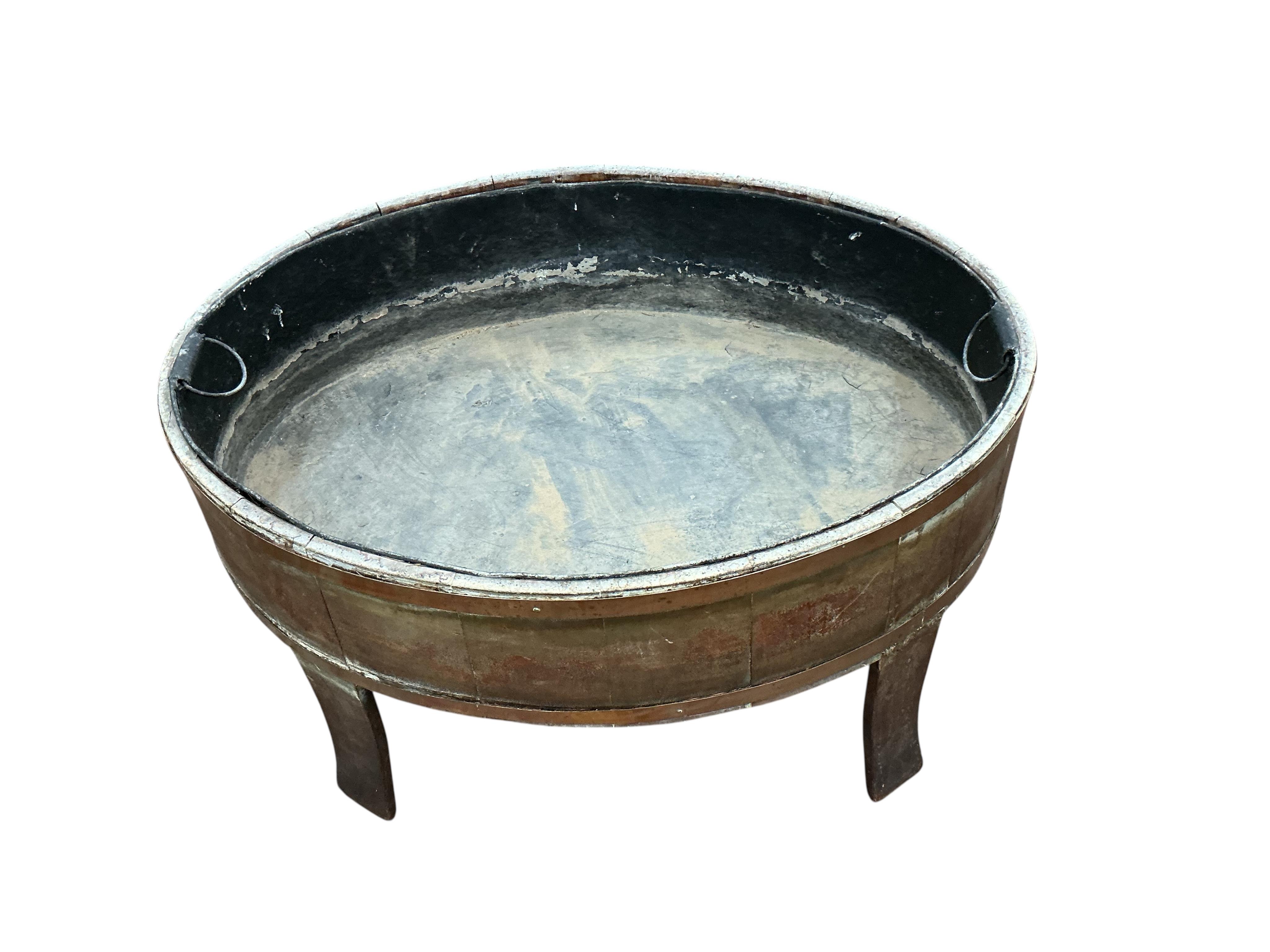 A George III brass bound staved mahogany oval wine cooler, width 92cm, depth 65cm, height 56cm